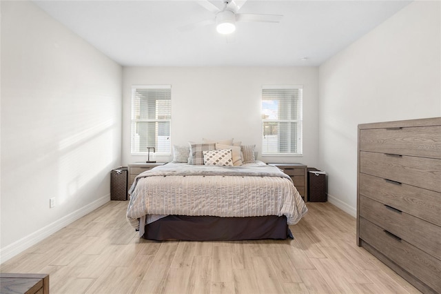 bedroom with light wood-style flooring, baseboards, and ceiling fan