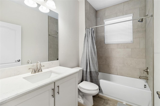 bathroom featuring toilet, wood finished floors, shower / bath combination with curtain, and vanity