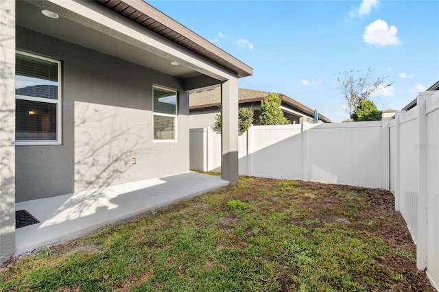 view of yard with a fenced backyard and a patio