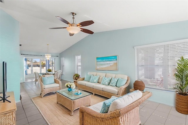 living area with light tile patterned floors, ceiling fan, baseboards, and vaulted ceiling