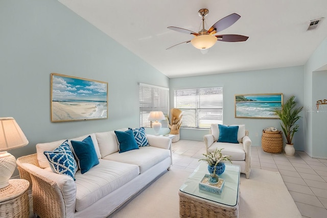 living room featuring tile patterned flooring, visible vents, vaulted ceiling, and a ceiling fan