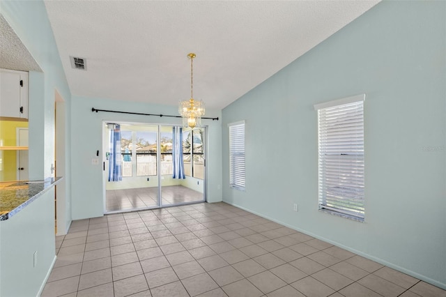 unfurnished dining area featuring visible vents, light tile patterned flooring, vaulted ceiling, a textured ceiling, and a chandelier