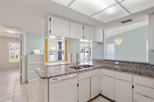 kitchen featuring light tile patterned floors, a sink, visible vents, white cabinetry, and dishwasher