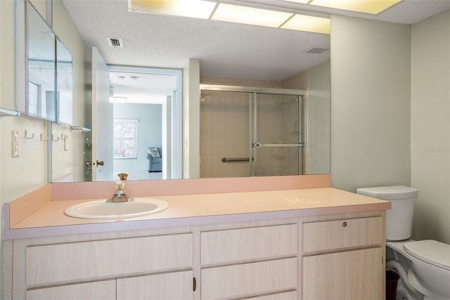 full bath with a stall shower, visible vents, vanity, and toilet