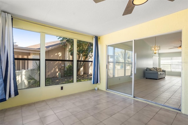 spare room featuring tile patterned flooring, a textured ceiling, and a ceiling fan