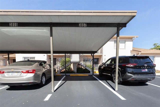 partially covered parking lot featuring stairway