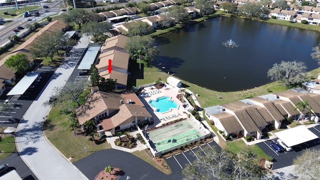 drone / aerial view featuring a water view and a residential view