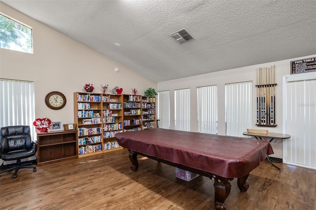 rec room with visible vents, wood finished floors, pool table, vaulted ceiling, and a textured ceiling