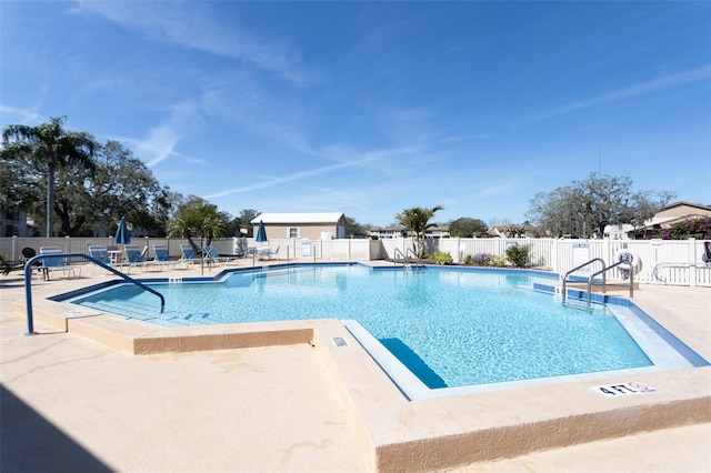 community pool featuring fence and a patio