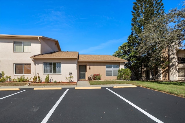 view of front of home featuring uncovered parking and stucco siding