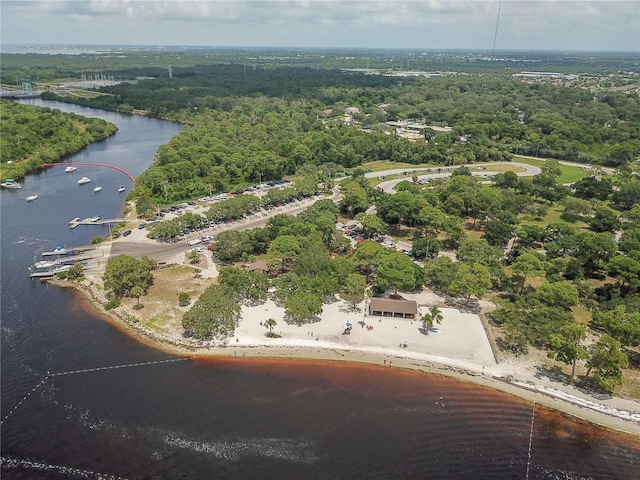 drone / aerial view featuring a water view and a wooded view