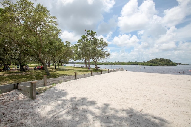 view of property's community with volleyball court and a water view