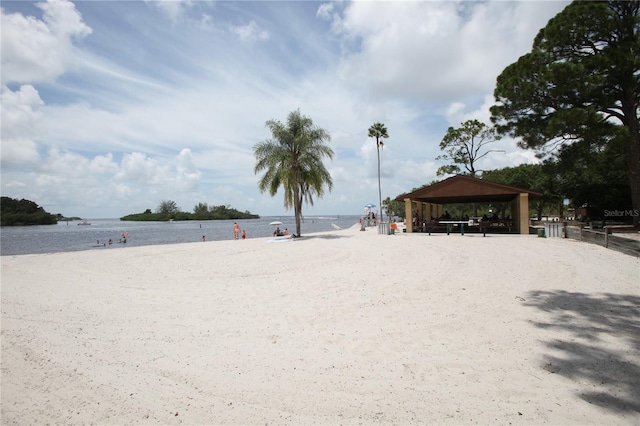 surrounding community with a water view and a gazebo