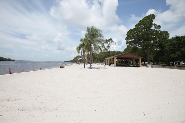 view of yard with a gazebo, a water view, and a view of the beach