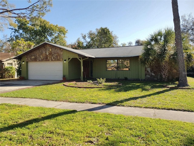 view of front of home with a garage, driveway, and a front lawn