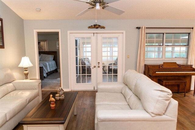 living area featuring a ceiling fan, dark wood-type flooring, and french doors