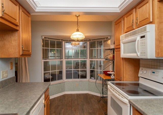 kitchen featuring white appliances, dark wood-style flooring, baseboards, light countertops, and decorative light fixtures