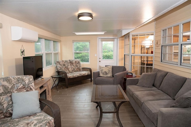 living room with a wall unit AC and wood finished floors
