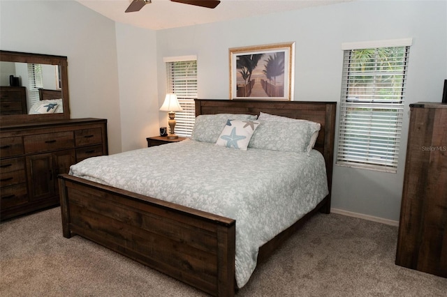bedroom with ceiling fan, baseboards, and light colored carpet