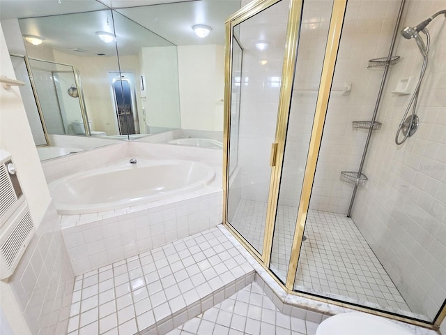 bathroom featuring a garden tub, a shower stall, toilet, and tile patterned floors