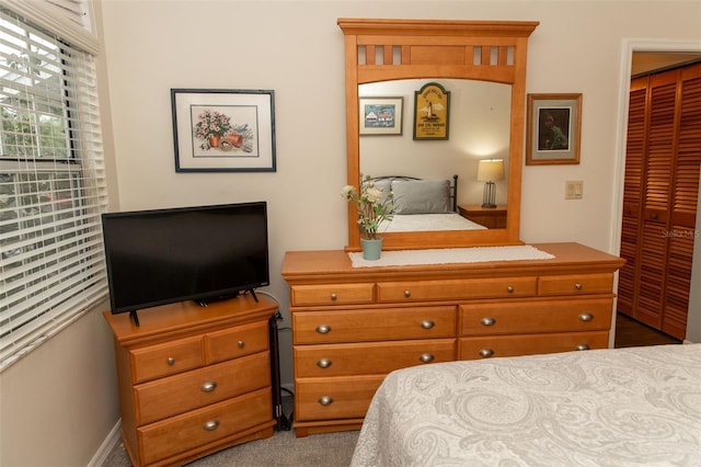 carpeted bedroom with a closet