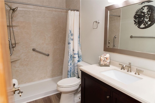 full bathroom featuring toilet, a shower with curtain, wood finished floors, and vanity