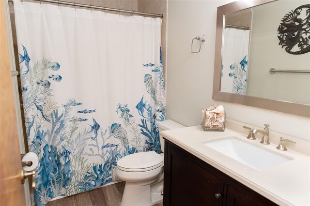 full bath featuring vanity, toilet, and wood finished floors