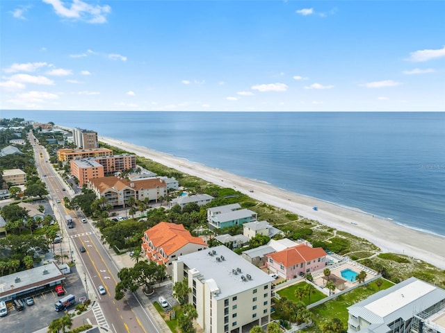 birds eye view of property with a water view and a beach view