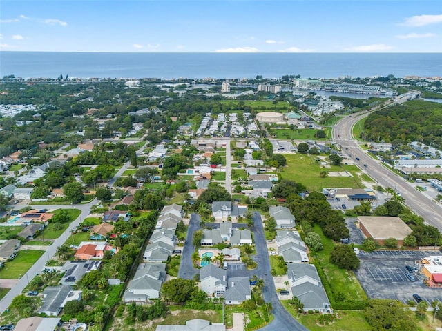 birds eye view of property with a water view and a residential view