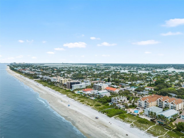 drone / aerial view featuring a water view and a beach view