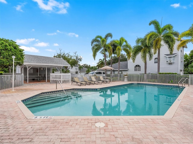 pool with fence and a patio