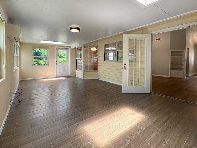 11722 Currie Ln Unit G1, Largo, FL 33774 - spare room featuring a wall mounted AC and wood finished floors