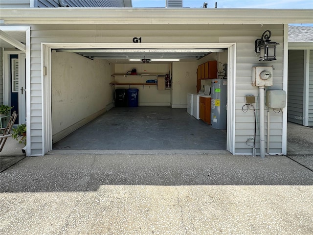 11722 Currie Ln Unit G1, Largo, FL 33774 - garage with electric water heater, driveway, and a garage door opener