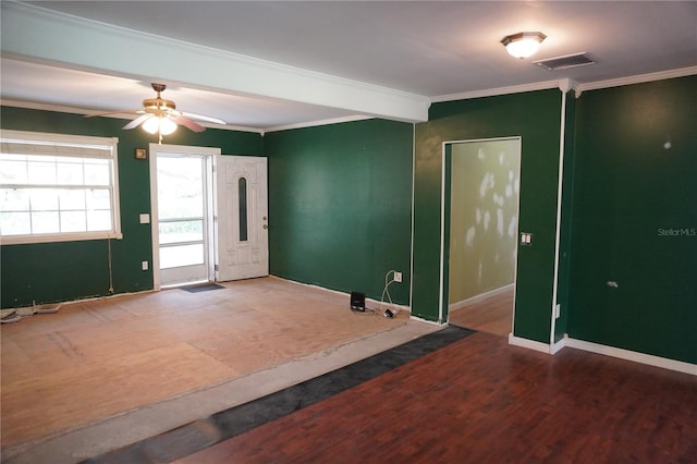 unfurnished room with visible vents, baseboards, ceiling fan, wood finished floors, and crown molding