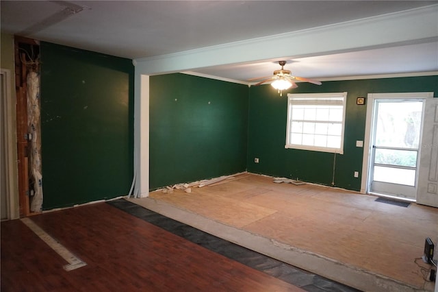 empty room with ornamental molding and a ceiling fan