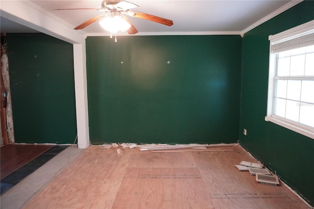 empty room with a ceiling fan and crown molding