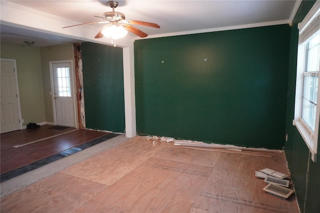 unfurnished room with crown molding, baseboards, and ceiling fan