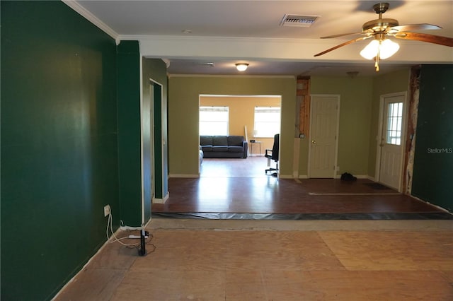 hallway featuring visible vents, crown molding, and baseboards