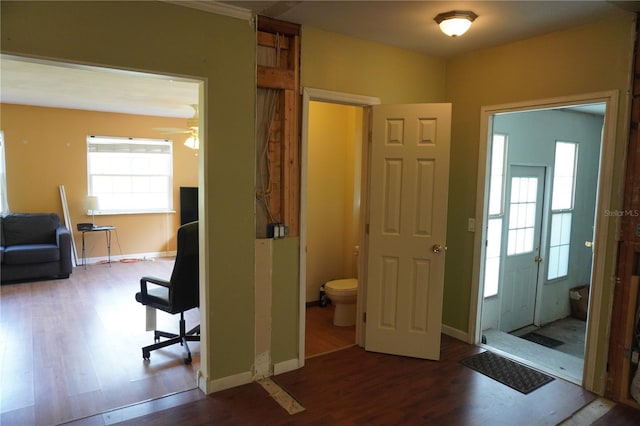 entryway with ceiling fan, baseboards, and wood finished floors