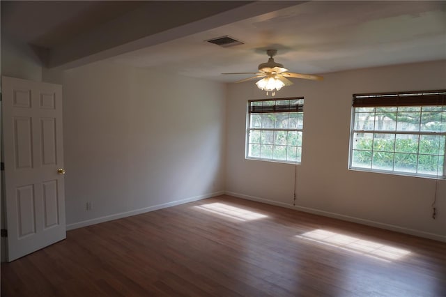 unfurnished room with a ceiling fan, baseboards, visible vents, and wood finished floors