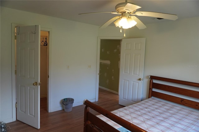 bedroom with ceiling fan, wood finished floors, and baseboards