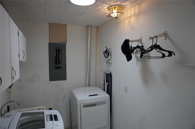 washroom featuring electric panel, cabinet space, and independent washer and dryer