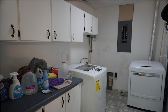 washroom with electric panel, cabinet space, light floors, and separate washer and dryer