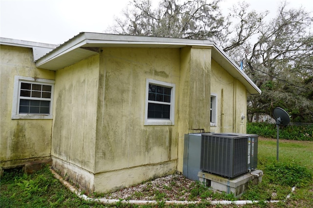 view of home's exterior with central AC unit and stucco siding