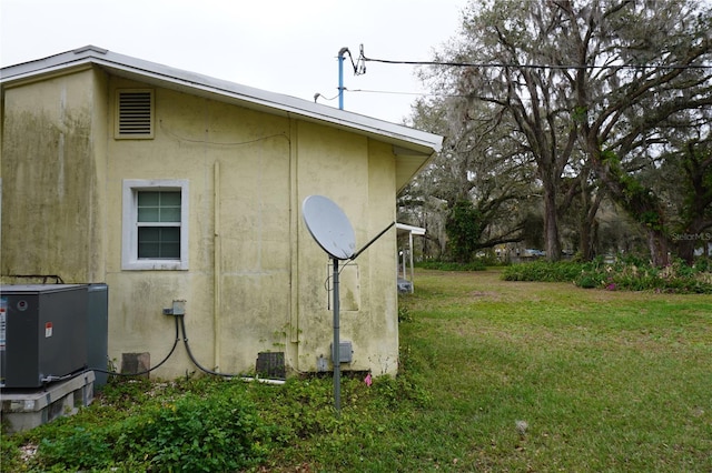 view of property exterior featuring a yard and stucco siding