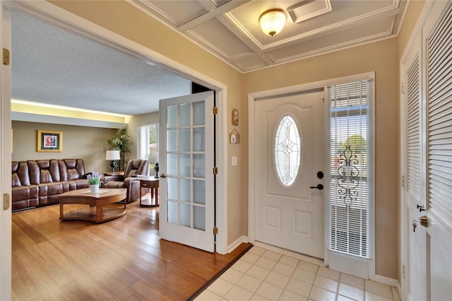 foyer entrance featuring light wood finished floors and baseboards