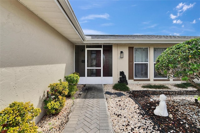 property entrance with stucco siding