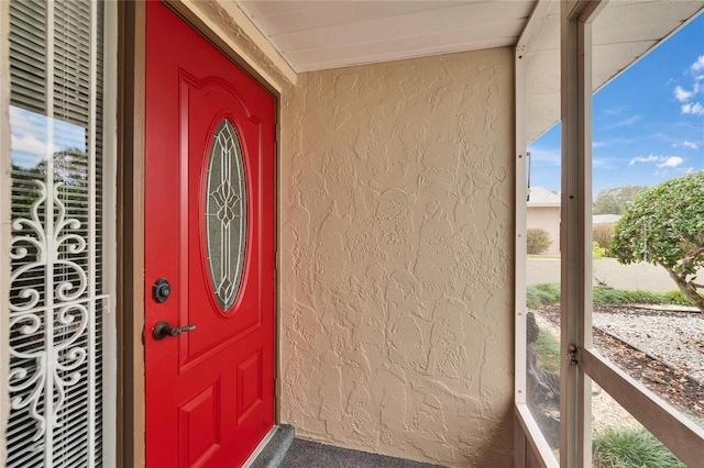 doorway to property with stucco siding