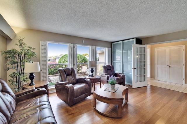 living area featuring a textured ceiling and light wood-style flooring