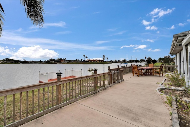 view of patio with outdoor dining area and a water view